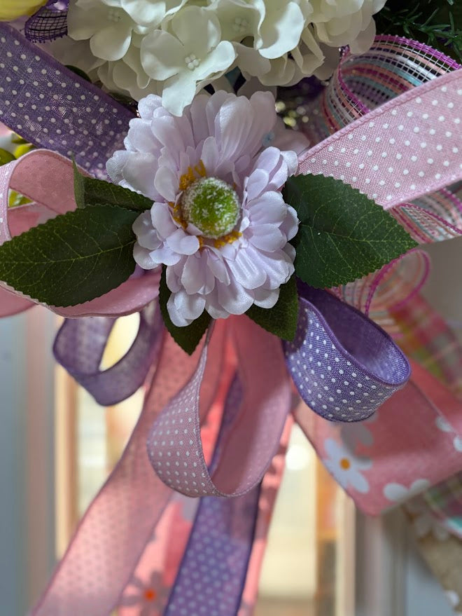 Close-up of lavender daisy with pink and purple polka dot ribbons