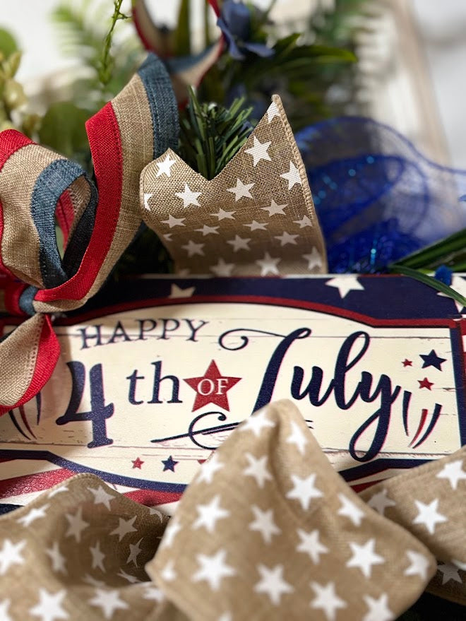 Close-up of Happy 4th of July sign with burlap star ribbon and patriotic bow