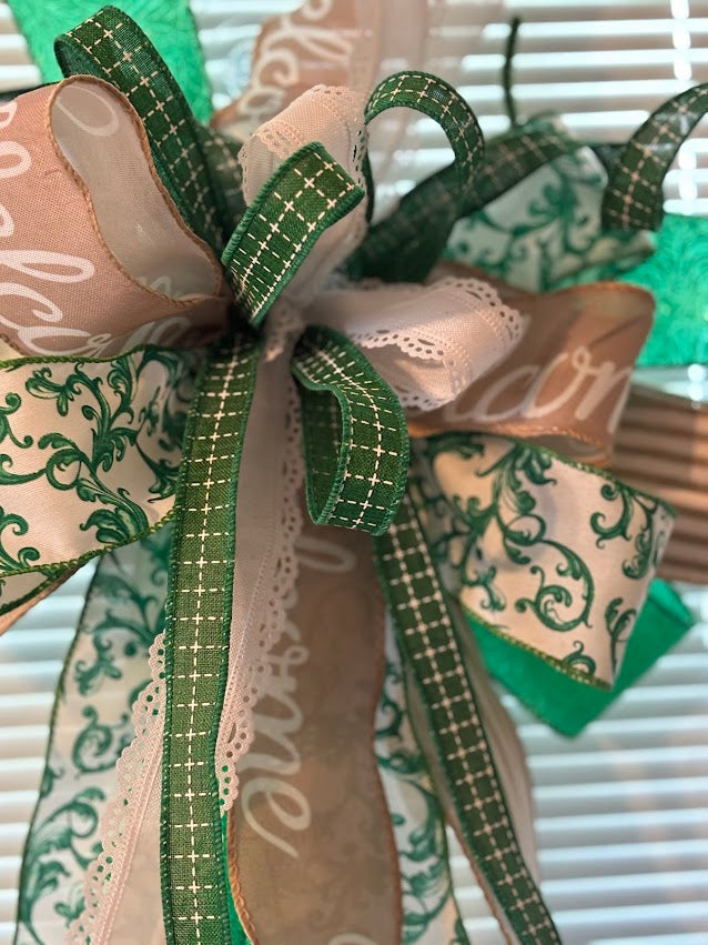 Emerald Chinoiserie Welcome bow close-up showing green plaid, cream scroll and lace ribbon detail