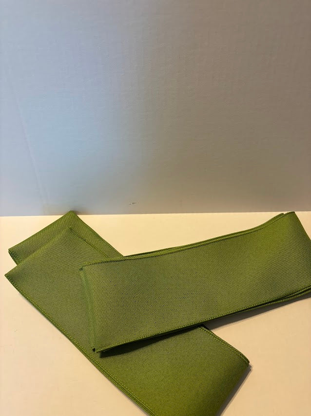 Olive green solid wired ribbon in 4 inch width showing smooth matte finish
