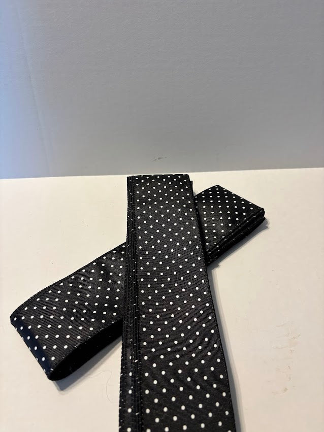 Close-up of black swiss dot wired ribbon showing dot pattern and wired edges