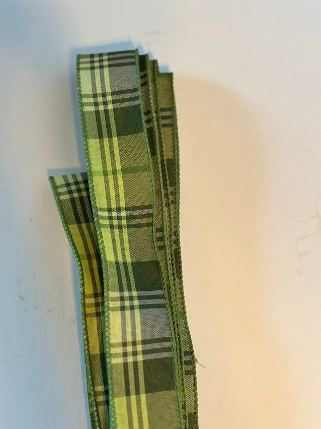 Close-up of sage green olive and cream tartan plaid wired ribbon