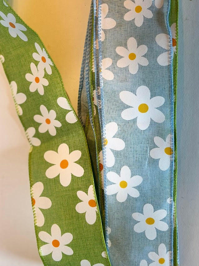 Close-up of daisy print wired ribbon in sage green and dusty blue
