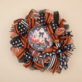 Boo Y'all Halloween wreath hanging on window